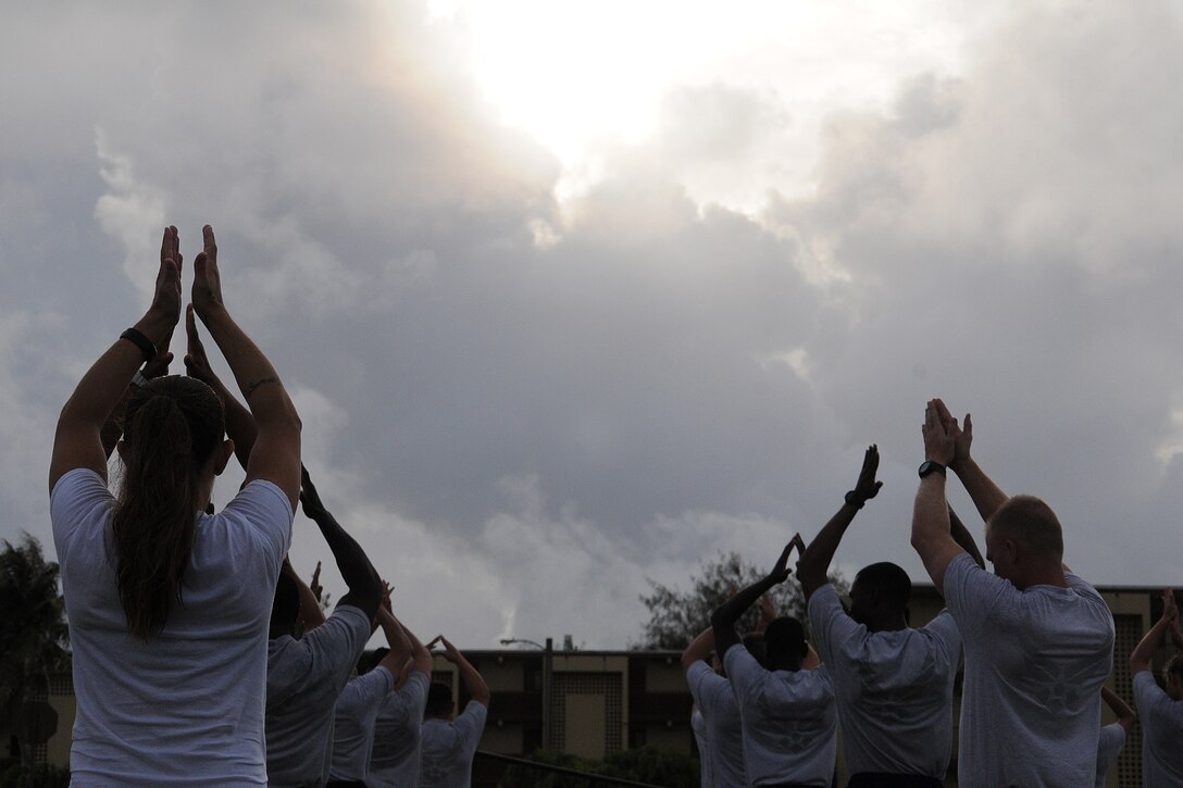 Members of the 36th Wing participate  in warm-up exercises in preparation for a Wing run at Andersen Air Force Base, Guam, June 14, 2013. Approximately 1,000 service members from the Air Force, U.S. Army and U.S. Navy participated in the run.(U.S. photo by Staff Sgt. Melissa White/Released)