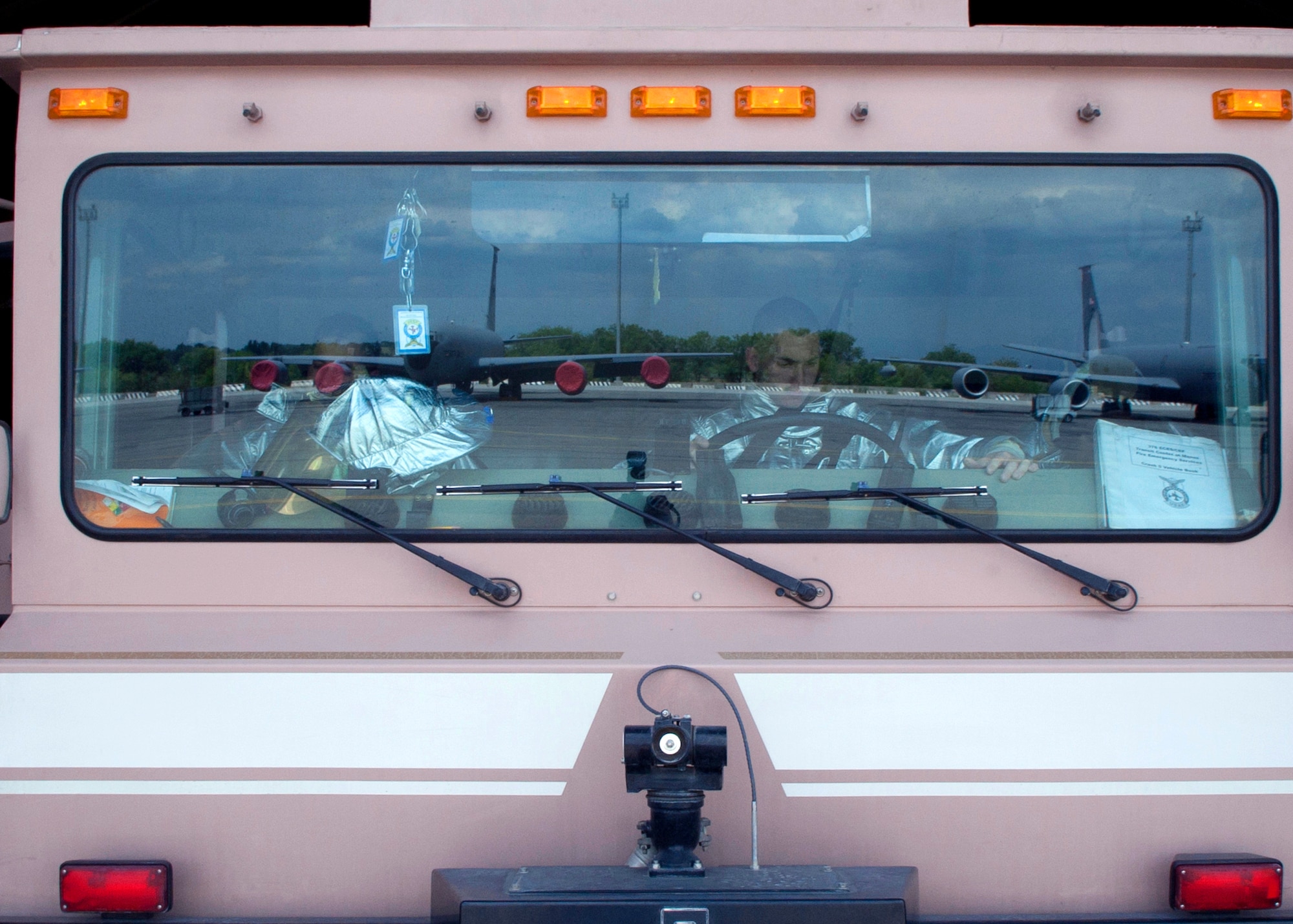 Airmen with the 376th Civil Engineer Squadron drive a fire truck onto the flight line in response to a simulated emergency scenario at Transit Center at Manas, Kyrgyzstan, June 12, 2013. A fire station is located on the flight line, and firefighters train regularly for immediate response to emergency and crisis situations. (U.S. Air Force photo/Staff Sgt. Robert Barnett)