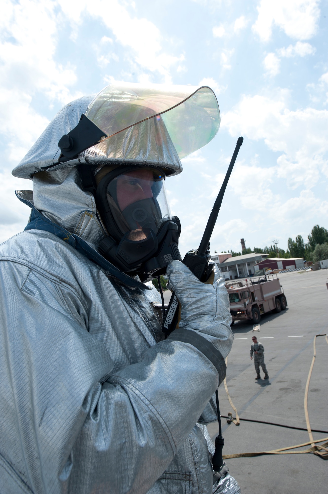 Staff Sgt. John Michael reports all victims cleared while standing on the wing of a KC-135 Stratotanker during an exercise at Transit Center at Manas, Kyrgystan, June 12, 2013. The firefighters performed an initial victim count into the KC-135 and confirmed the aircraft cleared of victims at the end of the scenario. Michael is deployed from Royal Air Force Lakenheath, and is a native of Lyndon, Kan. (U.S. Air Force photo/Staff Sgt. Robert Barnett)