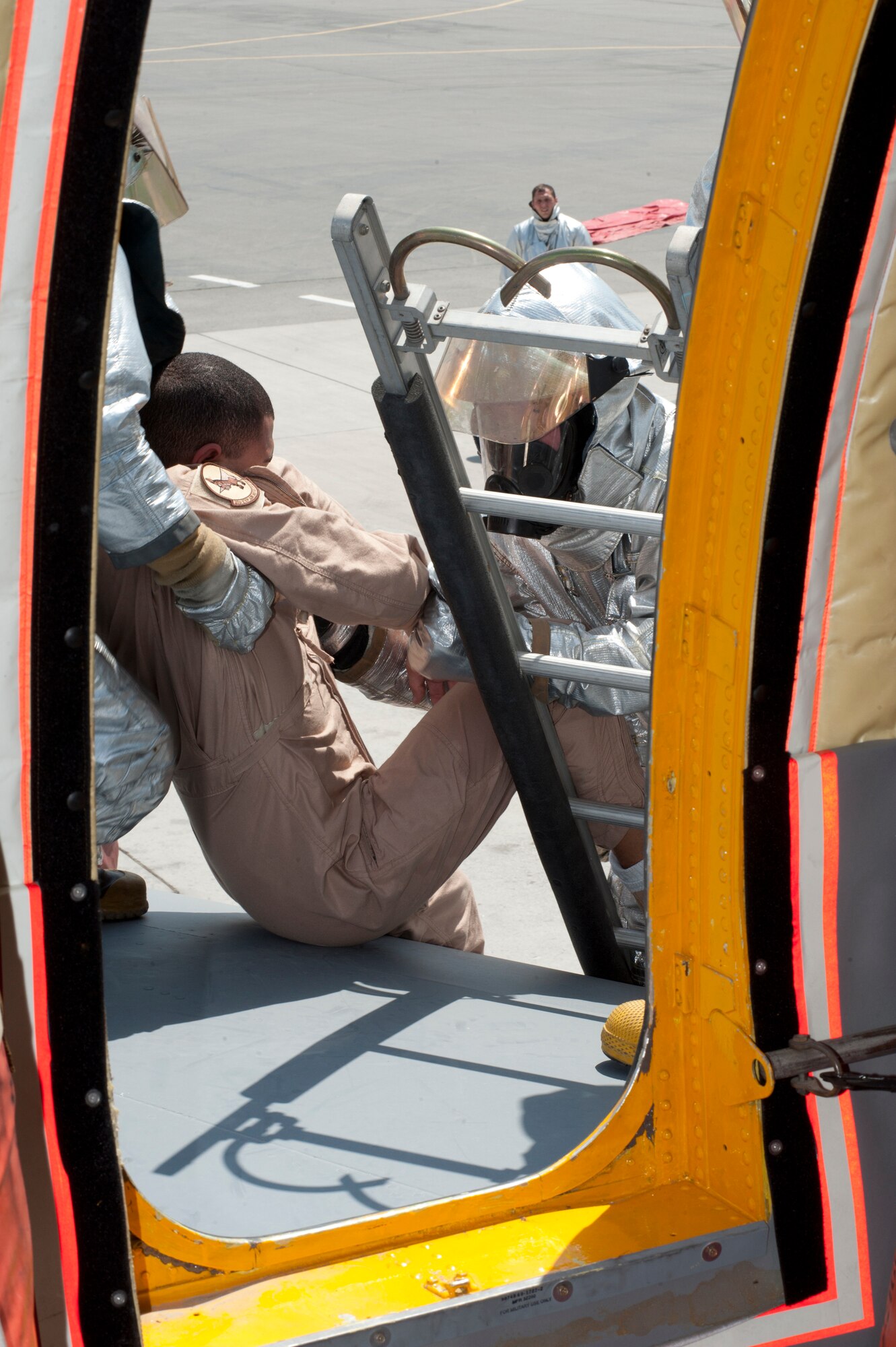 Senior Airmen Steven Rousseau, left, and Herbert Dixon, right, 376th Expeditionary Civil Engineer Squadron vehicle operator and crew chief, respectively carry a simulated victim onto a ladder from the left wing of a KC-135 Stratotanker during an exercise on the flightline at Transit Center at Manas, Kyrgyzstan, June 11, 2013. Rousseau is deployed from the Air Force Academy, Colo., and is a native of Colorado Springs, Colo. Dixon is deployed out of Barksdale Air Force Base, La., and is a native of Fort Smith, Ariz. (U.S. Air Force photo/Staff Sgt. Robert Barnett)