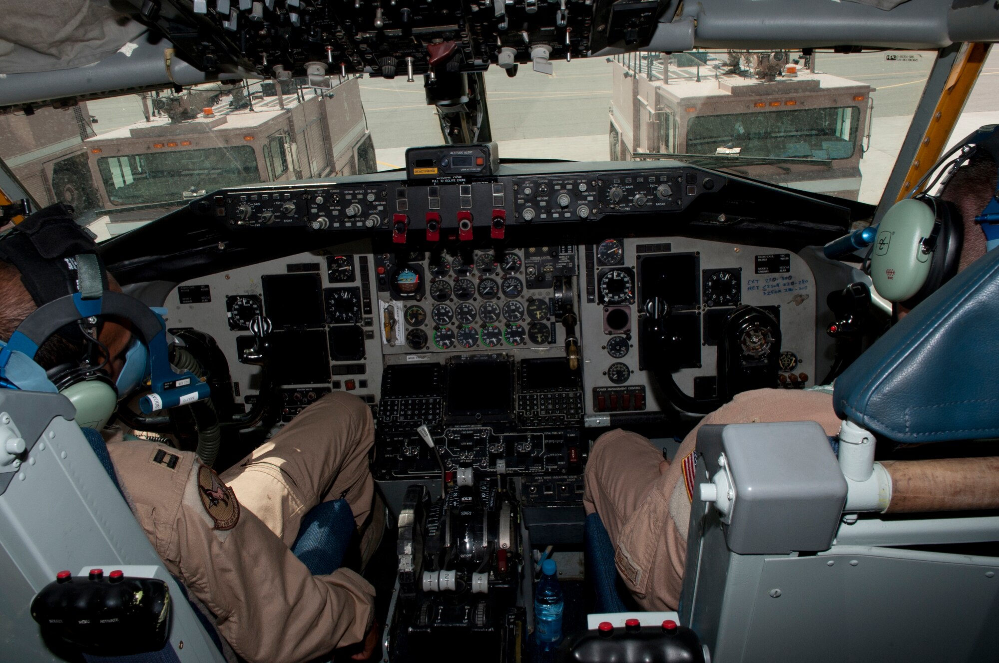 Two pilots simulate being unconscious as fire trucks stop in front the KC-135 Statotanker during a 376th Expeditionary Civil Engineer Squadron exercise at Transit Center at Manas, Kyrgyzstan, June 11, 2013. Several members from other units participated in the ECES exercise, simulating victims of an emergency scenario, to help the firefighters practice their skills. (U.S. Air Force photo/Staff Sgt. Robert Barnett)