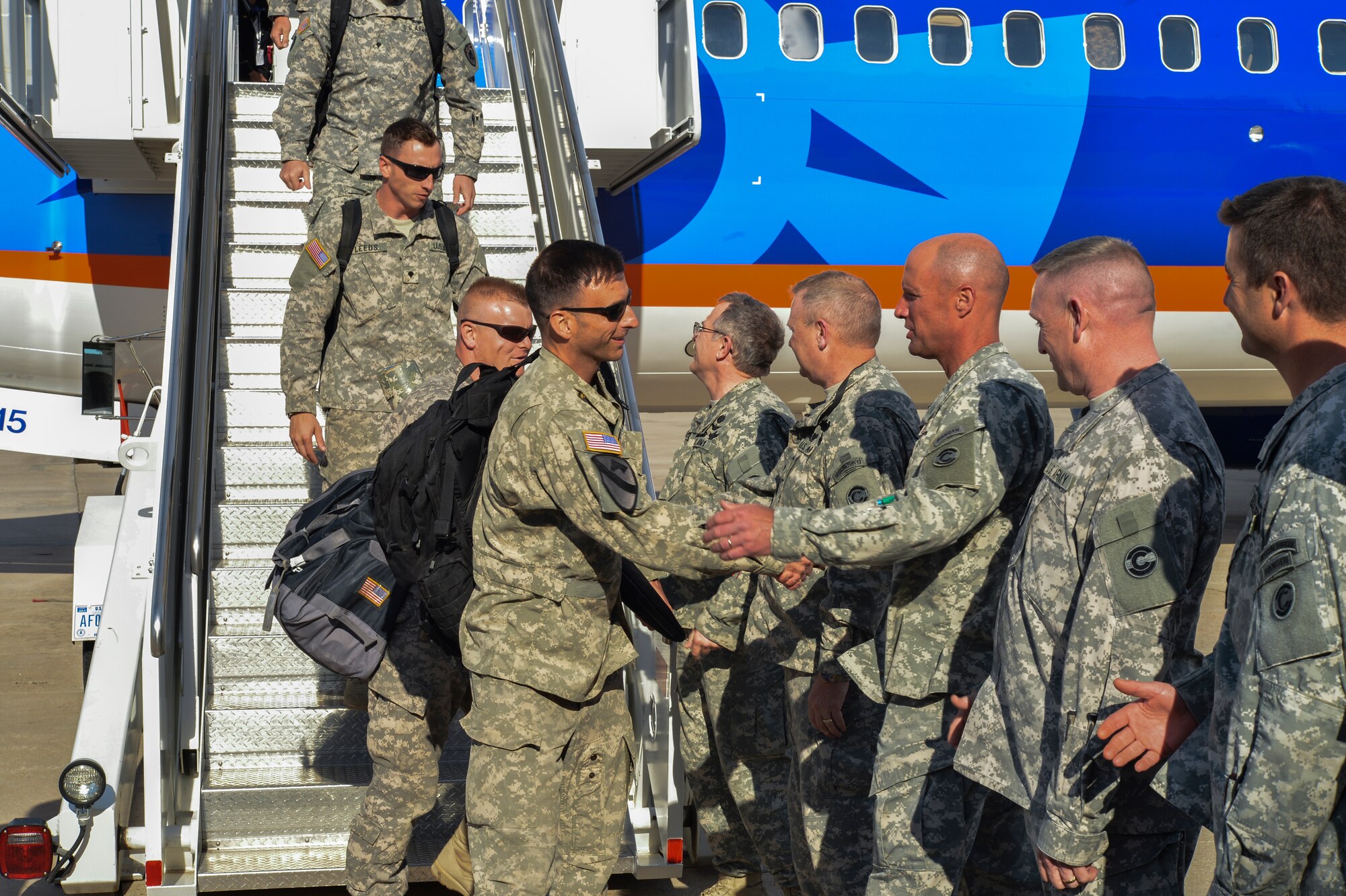 Senior leaders greets members of the 2nd Battalion, 135th Aviation Regiment as they step off a plane June 14, 2013, on Buckley Air Force Base, Colo. The battalion was established in the Colorado Army National Guard in the 1970s. (U.S. Air Force photo by Staff Sgt. Paul Labbe/Released)