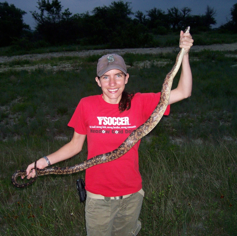 ERDC Construction Engineering Research Laboratory’s Dr. Jinelle Sperry holds a ratsnake captured at Fort Hood, Texas, and implanted with temperature sensitive radio transmitters to collect data on their thermoregulation patterns.  