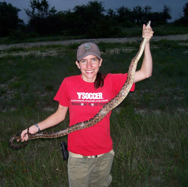 ERDC Construction Engineering Research Laboratory’s Dr. Jinelle Sperry holds a ratsnake captured at Fort Hood, Texas, and implanted with temperature sensitive radio transmitters to collect data on their thermoregulation patterns.  