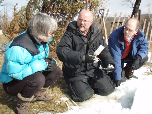 ERDC-CRREL Physical Science Technician Steve Decato, center, explains the snow crystal structure to CRREL Scientists Drs. Susan Frankenstein and John Weatherly during a recent snow pit training exercise.  Decato has been digging and profiling snow packs for more than 25 years.  