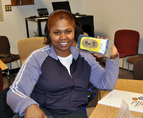 Math Teacher Tomeka Whitfield, Edison Middle School, displays her packaged potato from the Food Packaging Material World Module during a workshop at ERDC Construction Engineering Research Laboratory in March.  