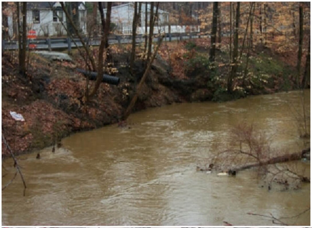 High flows have eroded the right bank of the Manasquan River at Howell Township and caused failure of the road shoulder and guide rail at the site.  The erosion has resulted in narrowing of the road width and replacement of the guide rail several times over the past few years. 
