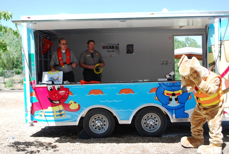 ALBUQUERQUE, N.M., -- Oh no! Bobber the Water Safety Dog misses a Frisbee disc thrown by Ranger John Mueller, Abiquiu Lake. Ranger Bob Garcia, Cochiti Lake, stands by to join in the fun. The rangers are standing in the new Water Safety Trailer.