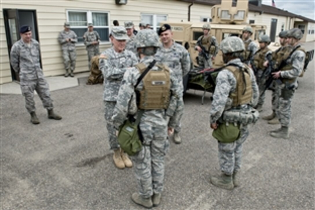 Army Gen. Martin E. Dempsey, chairman of the Joint Chiefs of Staff, talks with Air Force security forces on Minot Air Force Base, N.D., June 17, 2013.