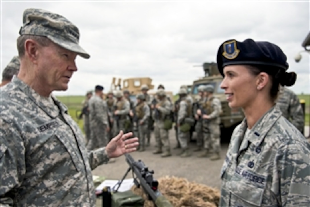 Army Gen. Martin E. Dempsey, chairman of the Joint Chiefs of Staff, talks with member of Air Force security forces on Minot Air Force Base, N.D., Jun 17, 2013. Dempsey visited Minot to observe Air Force operations and visit with airmen.