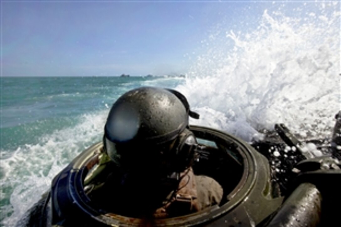 U.S. Marine Corps Cpl. Roger Skilling operates an assault amphibious vehicle during a simulated amphibious raid event with Thai marines during Cooperation Afloat Readiness and Training 2013 in Hat Yao, Thailand, June 10, 2013. Skilling is assigned to the 2nd Assault Amphibian Battalion, 2nd Marine Division, attached to Combat Assault Battalion, 3rd Marine Division, III Marine Expeditionary Force. 