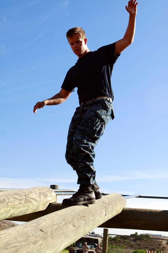 Midshipmen race through an obstacle course during Marine Week of Career Orientation and Training for Midshipmen-West 2013 here June 12. Future officers from across the U.S. participated in the four-weeks of training designed to introduce them to career opportunities.
