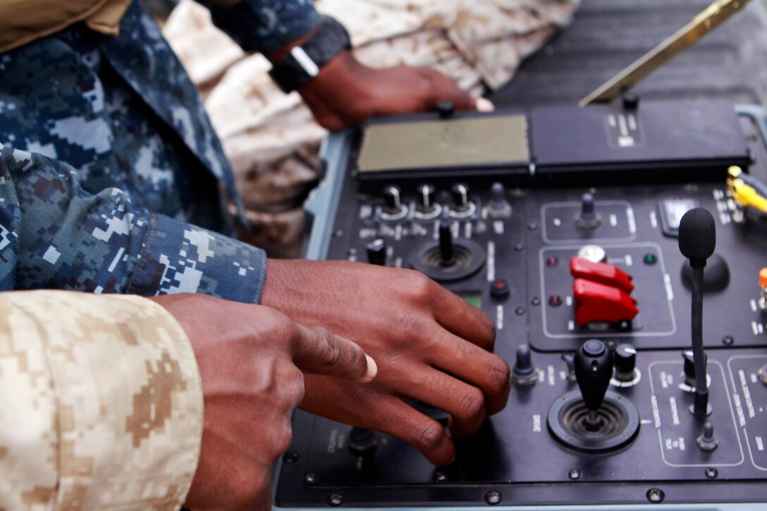 Midshipmen are given an exhibition on the use of Explosive Ordinance Disposal bomb defusing robot during Marine Week of Career Orientation and Training for Midshipmen-West 2013 here June 12. Future officers from across the U.S. participated in the four-weeks of training designed to introduce them to career opportunities.