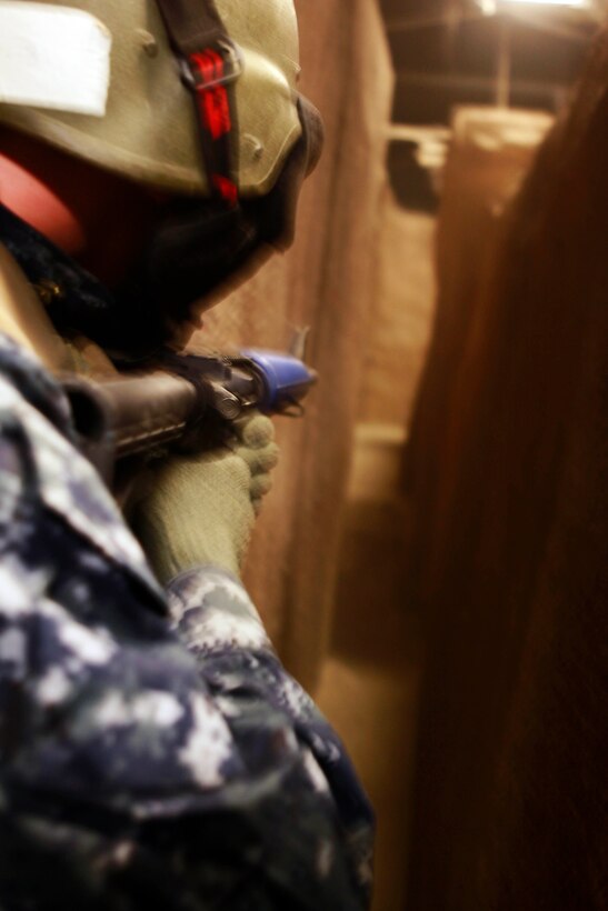 Midshipmen prepare to enter the Infantry Immersion Trainer to perform a combat simulation exercise during Marine Week of Career Orientation and Training for Midshipmen-West 2013 here June 12. Future officers from across the U.S. participated in the four-weeks of training designed to introduce them to career opportunities.