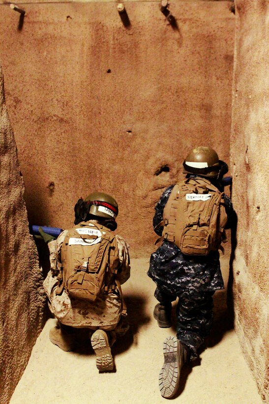 Midshipmen perform room clearing manuevers in the Infantry Immersion Trainer where a combat simulation exercise was conducted during Marine Week of Career Orientation and Training for Midshipmen-West 2013 here June 12. Future officers from across the U.S. participated in the four-weeks of training designed to introduce them to career opportunities.