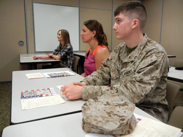 Pfc. Joshua Williams (left), administrative specialist at the Family Readiness Division, Headquarters Marine Corps, and military spouses, Kate Marini and Hannah Hicks attend the Personal Financial Management Program’s “Saving and Investing” workshop June 12, 2013, at the Religious Annex aboard Marine Corps Base Quantico.              