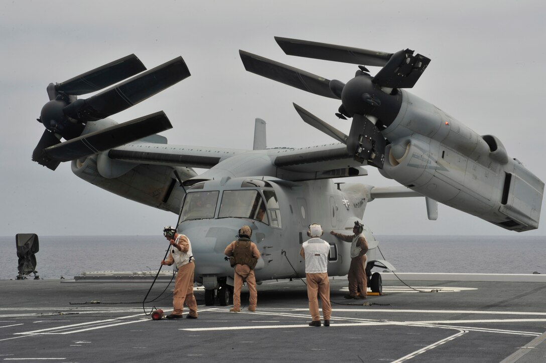 130614-N-BU440-372 PACIFIC OCEAN –U.S. Marines inspect an MV-22 Osprey tilt-rotor aircraft after landing on the Japan Maritime Self-Defense Force helicopter destroyer JS Hyuga (DDH 181) during amphibious exercise Dawn Blitz. Dawn Blitz is a scenario-driven exercise led by the U.S. 3rd Fleet and 1 Marine Expeditionary Force that will test participants in the planning and execution of amphibious operations through a series of live training events. (U.S. Navy photo by Mass Communication Specialist Seaman Molly A. Evans/Released)