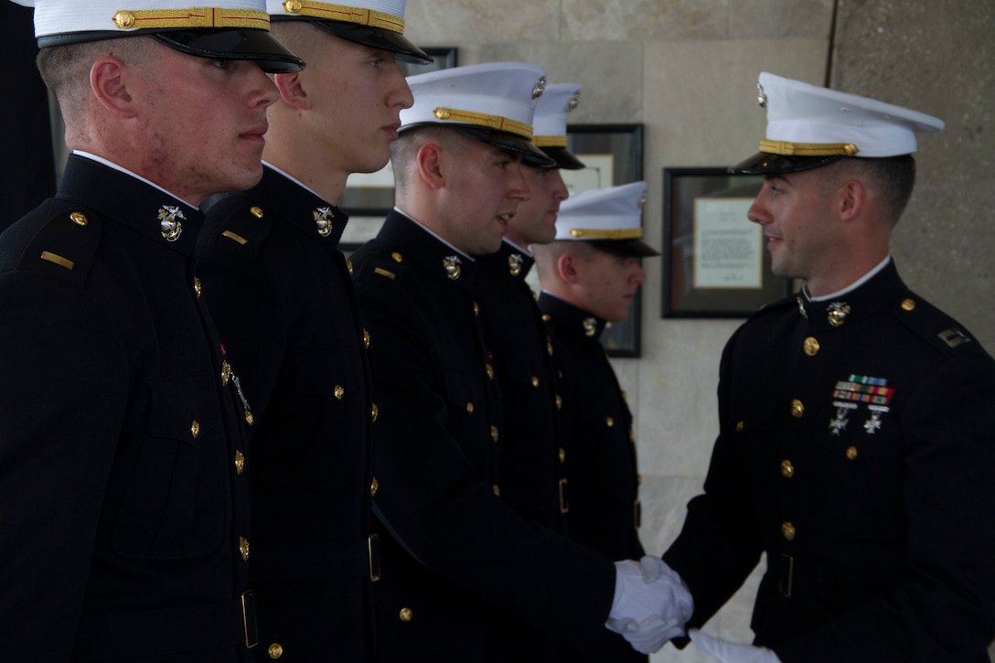 Capt. Joseph Leonardelli, Officer Selection Officer, congratulates newly commissioned Second Lieutenants from RS Milwaukee on taking their first steps as Marine Corps Officers, May 31. From left to right: 2nd Lts. Anthony Grandprey, Everett Brown, Jack Turek, Dustin Blanchard and Ryan Graves.