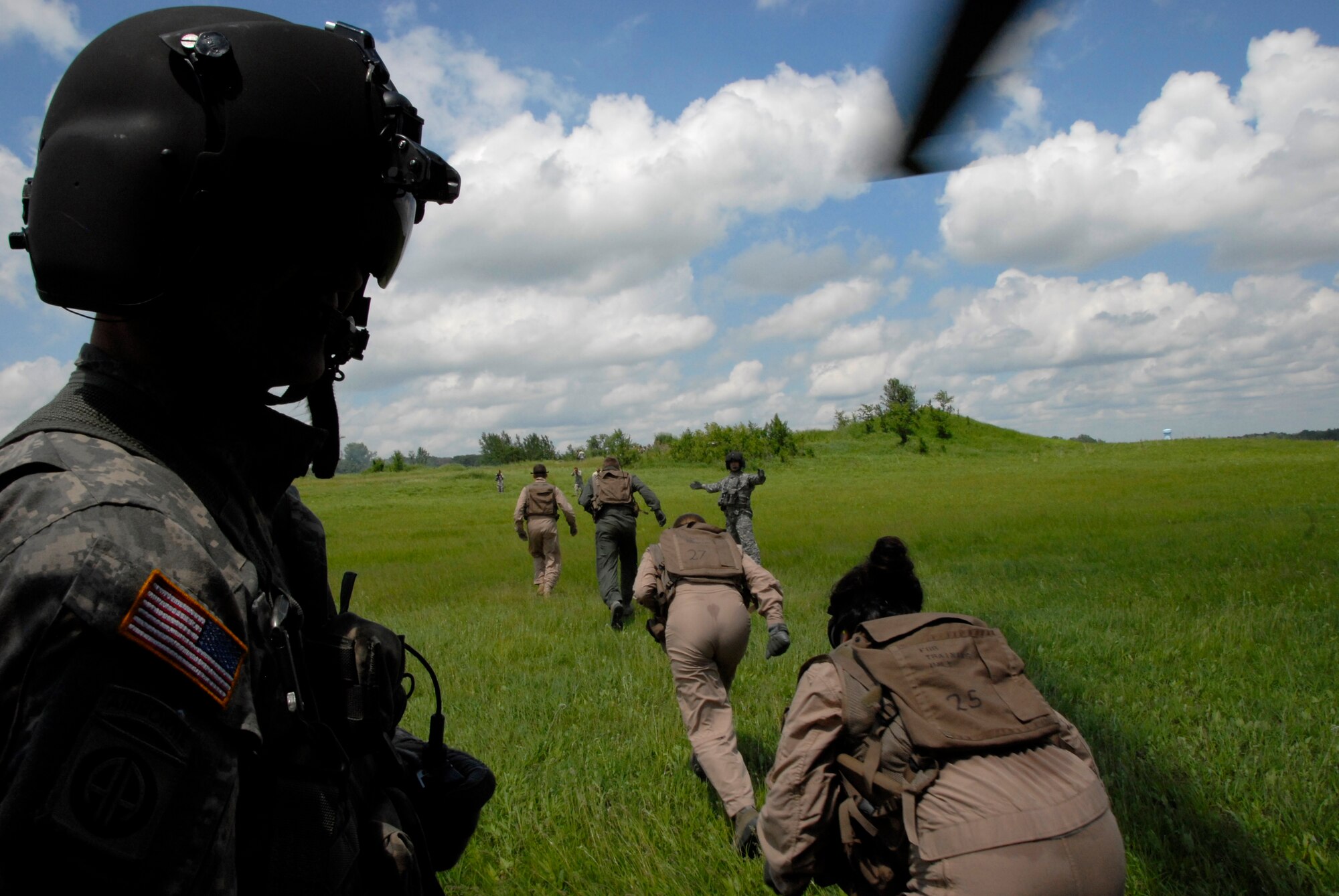 Soldiers of the Minnesota Army National Guard assist in the 133rd Airlift Wing’s combat and water survival training in Arden Hills, Minn., Jun. 18, 2013. Following their escape from their captors, Airmen exit the Black Hawk helicopter running towards the safety of their home base. 
(U.S. Air National Guard photo by Airman 1st Class Kari Giles/Released)

