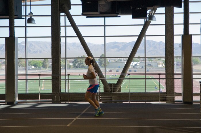 A woman runs on the indoor track at the Warrior Fitness Center on Nellis Air Force Base June 17, 2013. The gym offers an indoor as well as outdoor track for a variety of cardio exercises. The indoor track is one-eighth of a mile compared to quarter of a mile outdoor track. (U.S. Air Force Photo by Caitlin Kenney)  