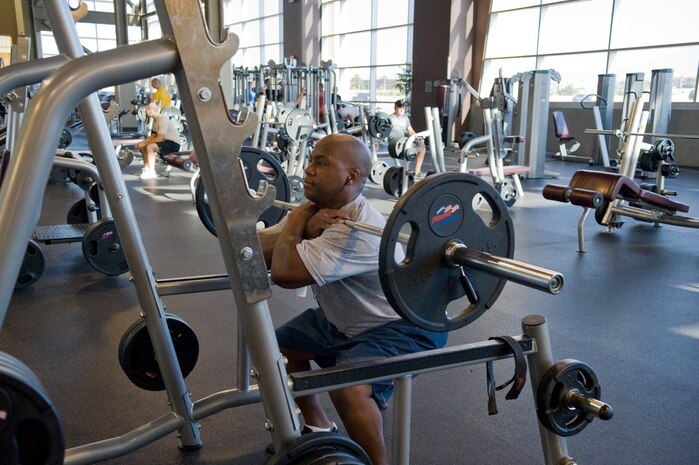 Neil Armstrong, 99th Contracting Squadron infrastructure flight NCO in charge, lifts weights at the Warrior Fitness Center on Nellis Air Force Base, Nev.,  June 17, 2013. Weights, cardio equipment and exercise classes are available to Department of Defense ID card holders and their family members. (U.S. Air Force Photo by Caitlin Kenney)  