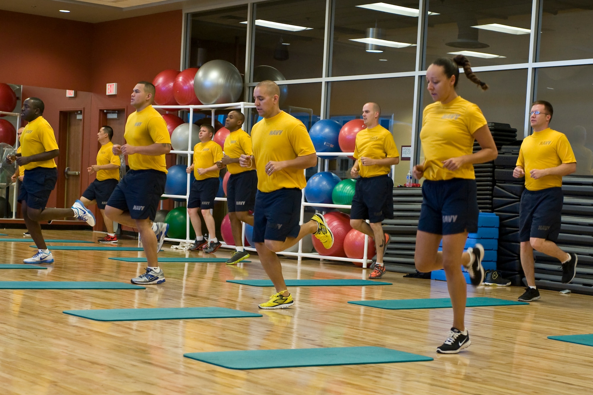 Members of Naval Recruiting District San Diego participate in group physical training at the Warrior Fitness Center on Nellis Air Force Base, Nev., June 17, 2013. Many military units in the Las Vegas area participate in group physical training at the fitness center. (U.S. Air Force photo by Senior Airman Matthew Lancaster)