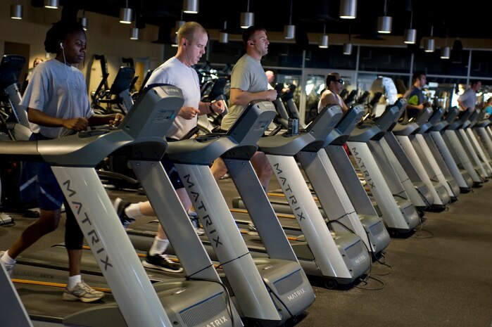 Men and women walk and run on treadmills at the Warrior Fitness Center on Nellis Air Force Base, Nev., June 17, 2013. The fitness center has ellipticals, stair climber machines, stationary bikes, treadmills and row machines for cardio workouts. To use the cardio equipment you need to be 16 or older. Proper fitness attire and proper running shoes are also a requirement. (U.S. Air Force photo by Senior Airman Matthew Lancaster)