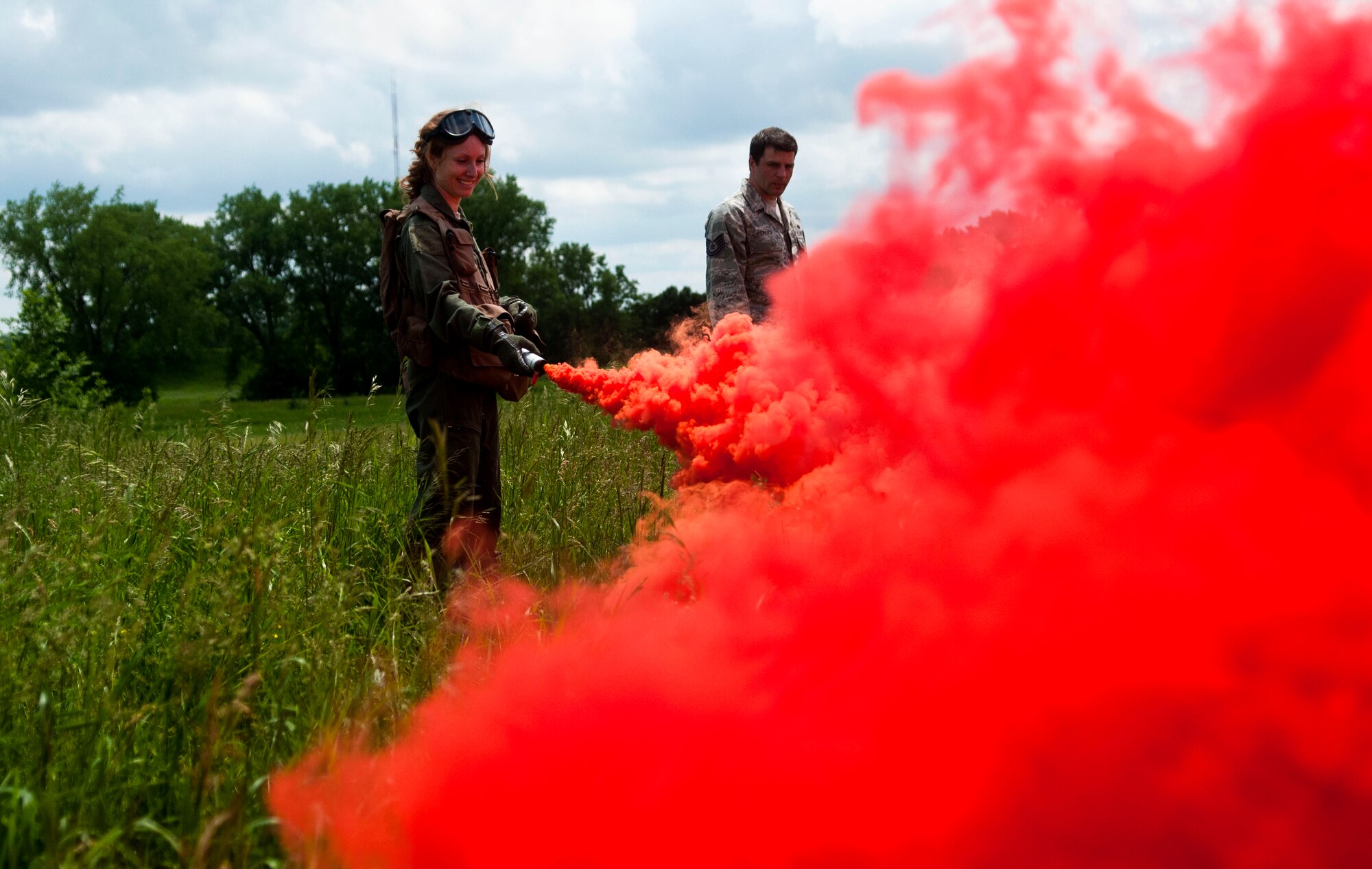 An Airman from the 133rd Airlift Wing ignites a smoke flair used to signal the Black Hawk helicopter for combat and water survival training in Arden Hills, Minn., Jun. 18, 2013. 
(U.S. Air National Guard photo by Staff Sgt. Austen Adriaens/Released)
