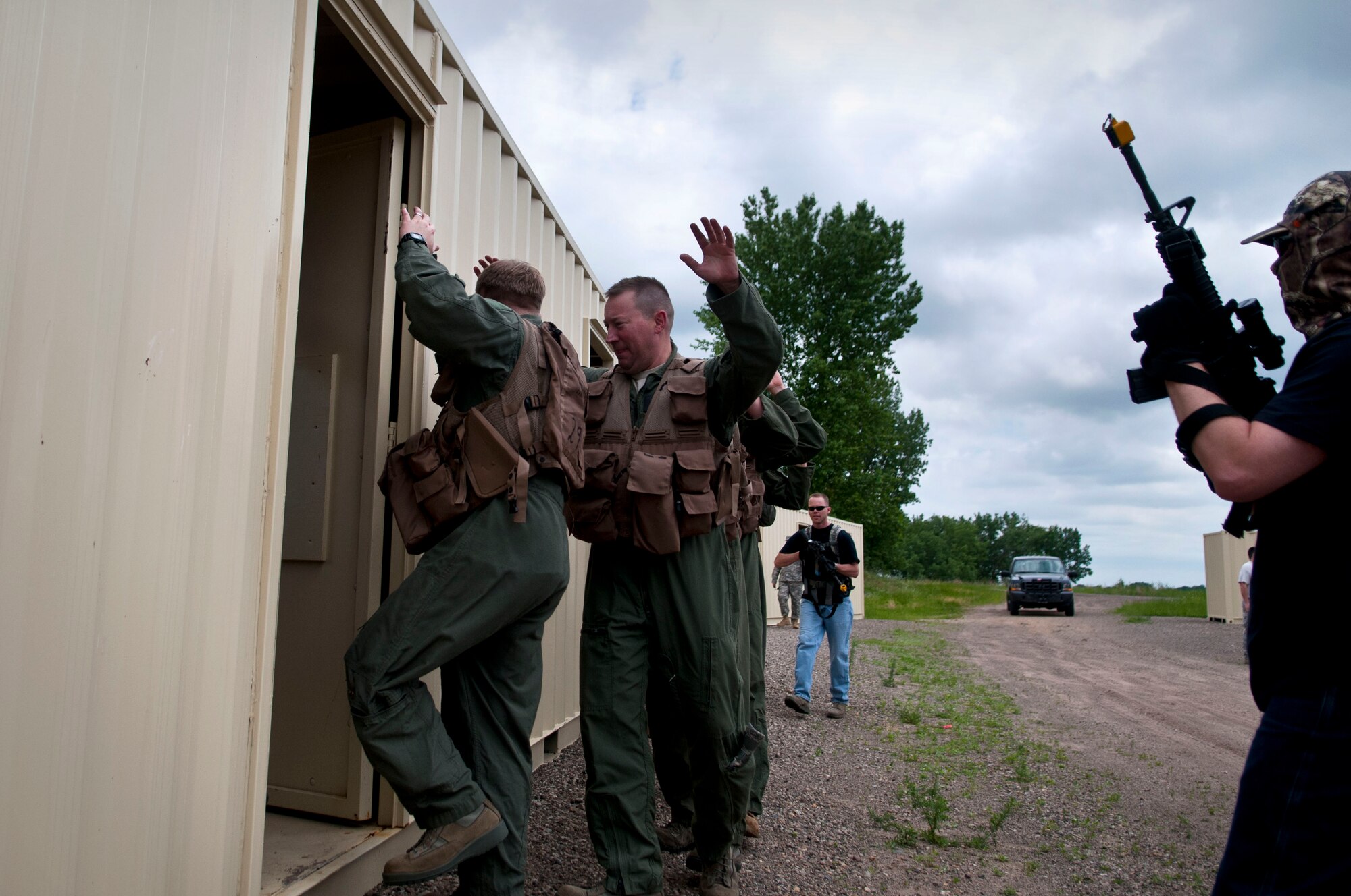 An Airman of the 133rd Security Forces Squadron, right, plays the role of an enemy captor at Arden Hills, Minn., Jun. 18, 2013. The Airman provides a sense of realism to the members of the 109th Airlift Squadron and 109th Aeromedical Evacuation Squadron that are going through combat and water survival training. 
 (U.S. Air National Guard photo by Staff Sgt. Austen Adriaens/Released)
