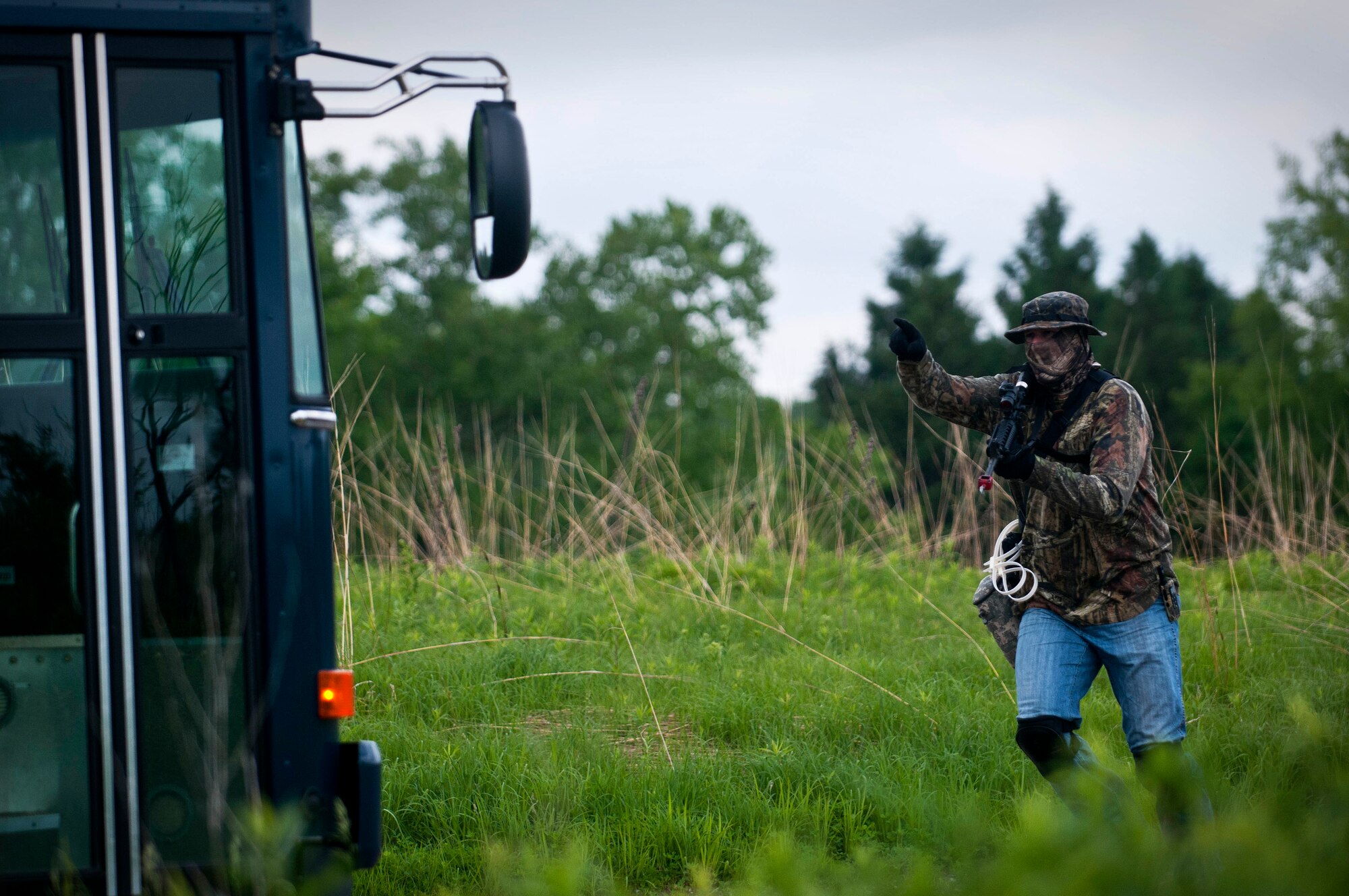 An Airman from the 133rd Security Forces Squadron storms the bus in Arden Hills, Minn., Jun. 18, 2013. The Airman provides a sense of realism to the members of the 109th Airlift Squadron and 109th Aeromedical Evacuation Squadron that are going through combat and water survival training. 
(U.S. Air National Guard photo by Staff Sgt. Austen Adriaens/Released)
