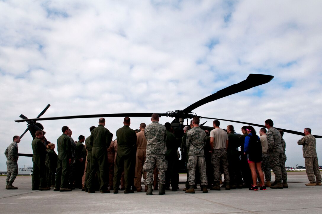 Members of the 133rd Airlift Wing get familiar with the Black Hawk helicopter prior to combat and water survival training at St. Paul, Minn., Jun. 18, 2013. 
 (U.S. Air National Guard photo by Staff Sgt. Austen Adriaens/Released) 
