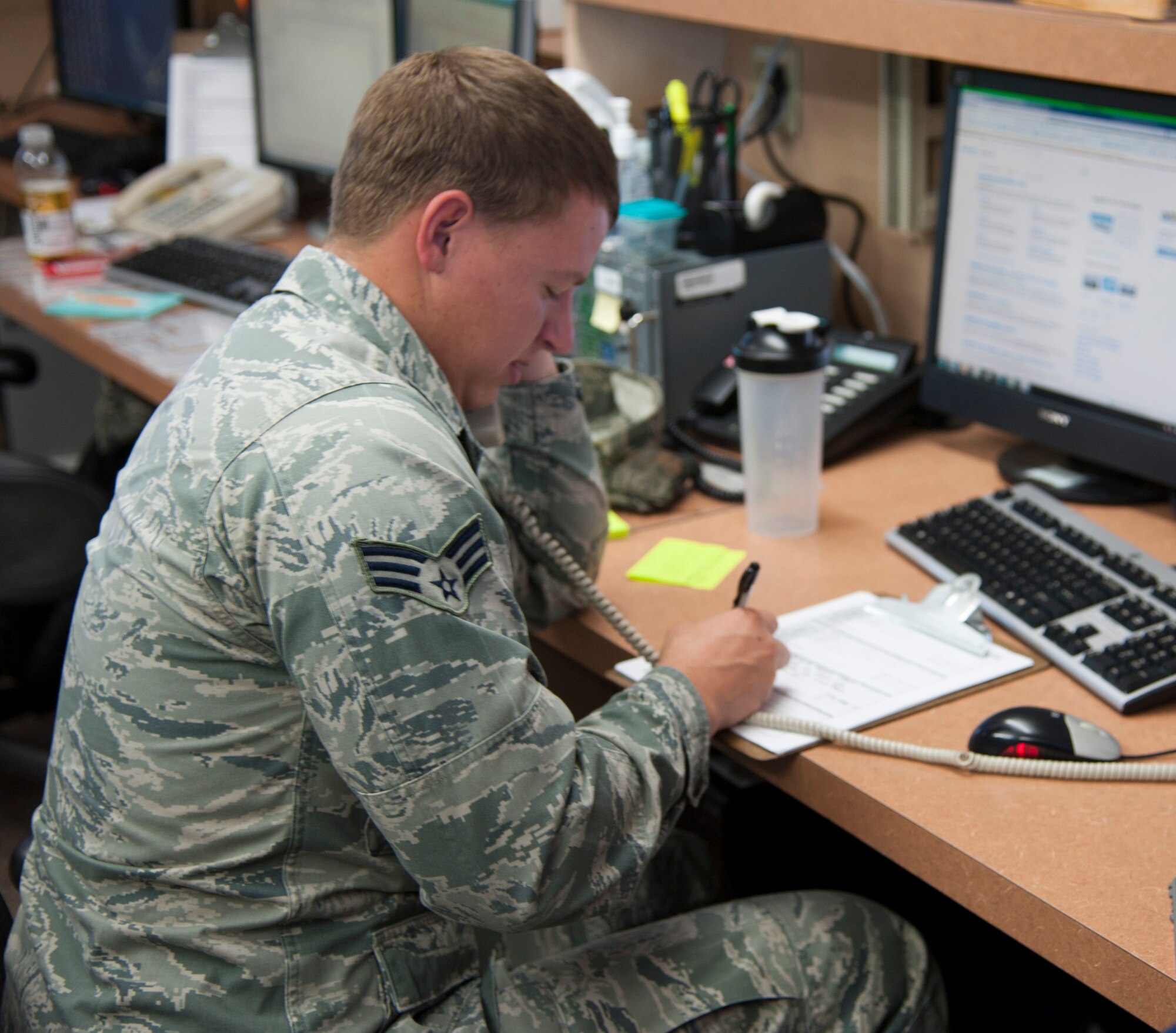 Senior Airman George Trosper, 47th Operations Support Squadron forecaster, informs a pilot on current weather conditions in their area at Laughlin Air Force Base, Texas, June 5, 2013. The phone calls from pilots are important because they receive critical information on the weather that affects their flight paths. (U.S. Air Force photo/Airman 1st Class Jimmie D. Pike)