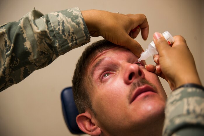 Maj. Syreeta Lawrence, 628th Medical Group optometrist, dilates a patient's  eyes June 17, 2013, at Joint Base Charleston – Air Base, S.C. Optometrists examine, diagnose, treat and manage diseases, injuries and disorders of the visual system, the eye and associated structures, as well as identify related systemic conditions affecting the eye. (U.S. Air Force photo/ Senior Airman George Goslin)
