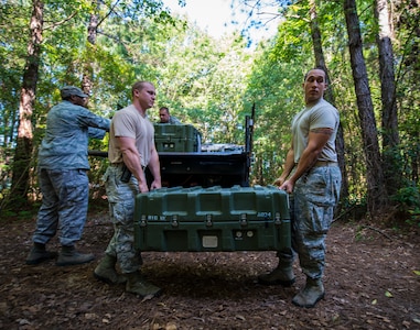 Staff Sgt. Theresa Davis, 628th Logistics Readiness Squadron Individual Protective Equipment technician, checks to make sure the serial numbers in the M-16 cases match her roster before transporting M-16 rifles to Airmen at the 628th Security Forces Squadron Combat Arms Training for an inspection June 13, 2013, at Joint Base Charleston, S.C. Davis is armed with an M-9 pistol since she will be escorting the weapons to the CATAM building. (U.S. Air Force photo/ Senior Airman Dennis Sloan)