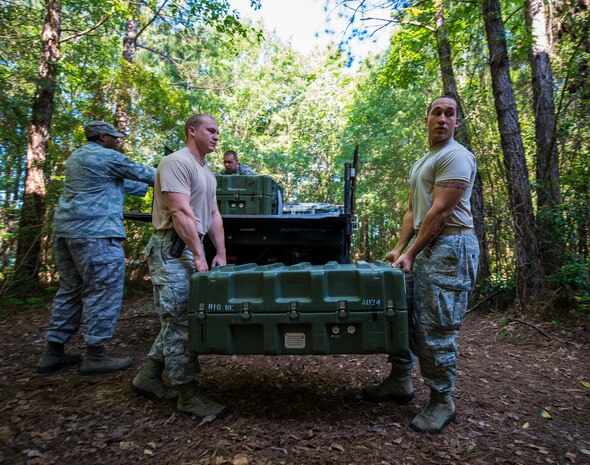 Staff Sgt. Theresa Davis, 628th Logistics Readiness Squadron Individual Protective Equipment technician, checks to make sure the serial numbers in the M-16 cases match her roster before transporting M-16 rifles to Airmen at the 628th Security Forces Squadron Combat Arms Training for an inspection June 13, 2013, at Joint Base Charleston, S.C. Davis is armed with an M-9 pistol since she will be escorting the weapons to the CATAM building. (U.S. Air Force photo/ Senior Airman Dennis Sloan)