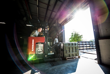 Senior Airman Robert Reynolds, 628th Logistics Readiness Squadron Individual Protective Equipment technician, moves four cases of M-16 rifles from the LRS vault to a truck to be transported to Airmen at the 628th Security Forces Squadron Combat Arms Training for an inspection June 13, 2013, at Joint Base Charleston – Air Base, S.C. The CATAM instructors are required to inspect all of the M-16s held in the vault once every year. (U.S. Air Force photo/ Senior Airman Dennis Sloan)