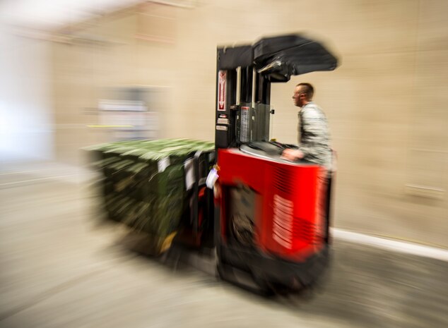 Senior Airman Robert Reynolds, 628th Logistics Readiness Squadron Individual Protective Equipment technician, moves four cases of M-16 rifles from the LRS vault to a truck to be transported to Airmen at the 628th Security Forces Squadron Combat Arms Training for an inspection June 13, 2013, at Joint Base Charleston – Air Base, S.C. The CATAM instructors are required to inspect all of the M-16s held in the vault once every year. (U.S. Air Force photo/ Senior Airman Dennis Sloan) 