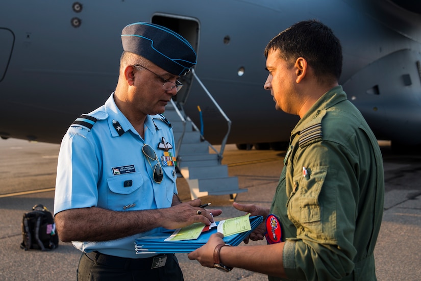 Indian air force Air Commodore Sanjay Nimesh  examines paperwork with Wing Commander Praveen, June 13, 2013, at Joint Base Charleston – Air Base, S.C. The Indian air force received its first of 10 C-17 Globemaster IIIs from Boeing, with the remainder being delivered through 2014. (U.S. Air Force photo/ Senior Airman George Goslin)