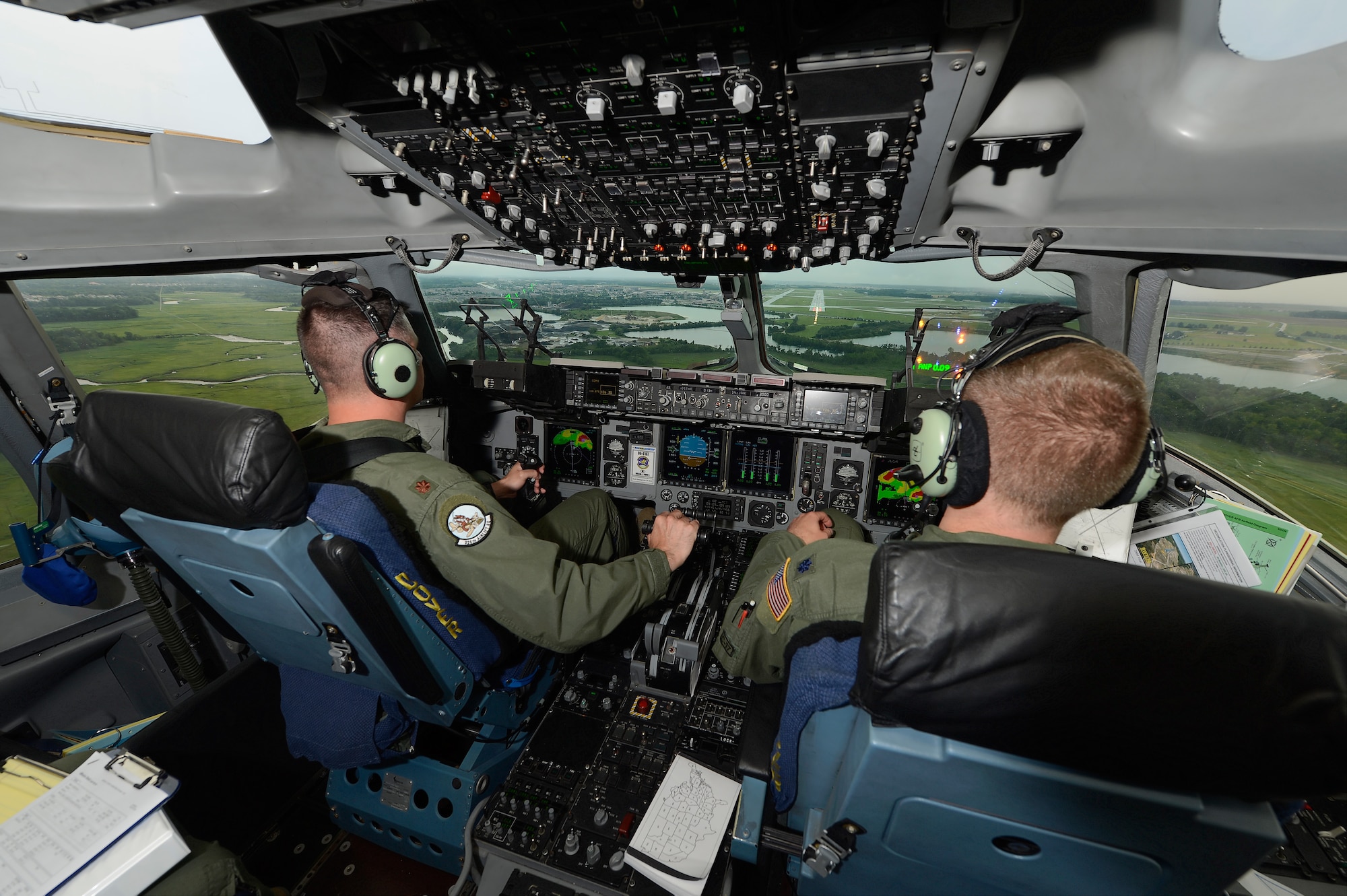 Maj. Rich Polehemus (left) and Lt. Col. Hugh Hamilton, C-17A pilots of the 326th Airlift Squadron, 512th Airlift Wing, Air Force Reserve Command, conduct an Instrument Landing System (ILS) approach to runway 01 at Dover Air Force Base on June 18, 2013. Clearly visible on the multi-function cockpit displays is the weather picture showing heavy rain in red. Dover's fleet of C-5M and C-17A's are shared by active duty (436th) and reserve (512th) Wings. (U.S. Air Force photo/Greg L. Davis)