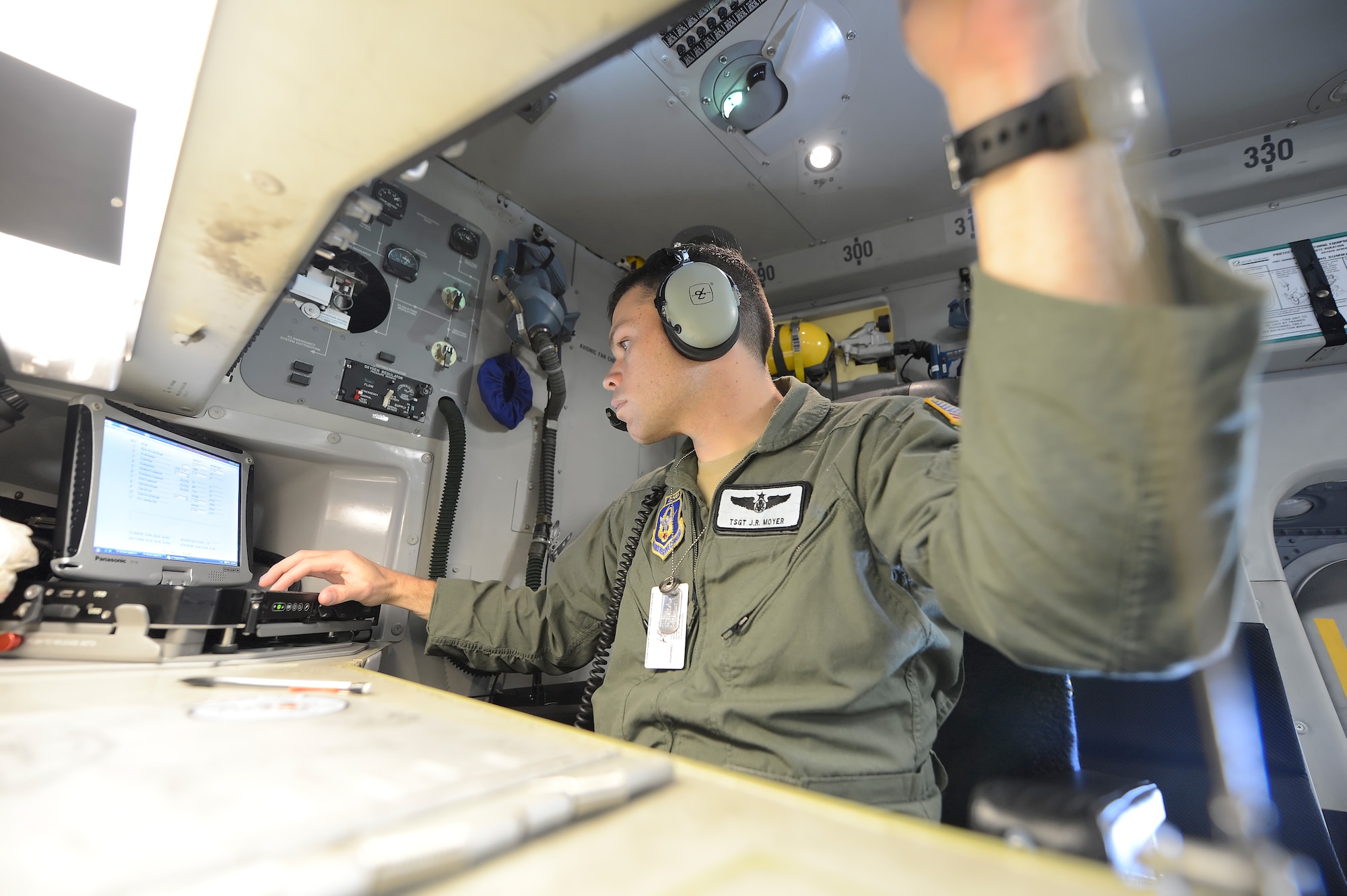 Technical Sgt. J. R. Moyer, a C-17A loadmaster with the 326th Airlift Squadron, 512th Airlift Wing, Air Force Reserve Command, works at the loadmasters station in the forward section of the cargo compartment during a training mission on June 18, 2013, from Dover Air Force Base, Del. Dover's fleet of C-5M and C-17A's are shared by active duty and reserve component personnel. (U.S. Air Force photo/Greg L. Davis)