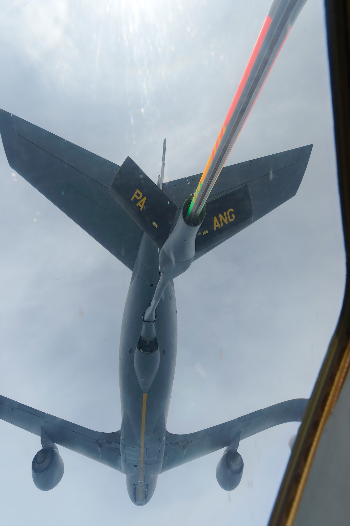 A KC-135R Stratotanker of the 171th Air Refueling Wing, Pennsylvania Air National Guard conducting in-flight refueling for a C-17A flown by members of the 326th Airlift Squadron, 512th Airlift Wing, Air Force Reserve Command, over the Eatern United States during a training mission on June 18, 2013. The KC-135's boom operator was Tech. Sgt. Kirk Boring who can be seen perring down from the boom-pod  (U.S. Air Force photo/Greg L. Davis)