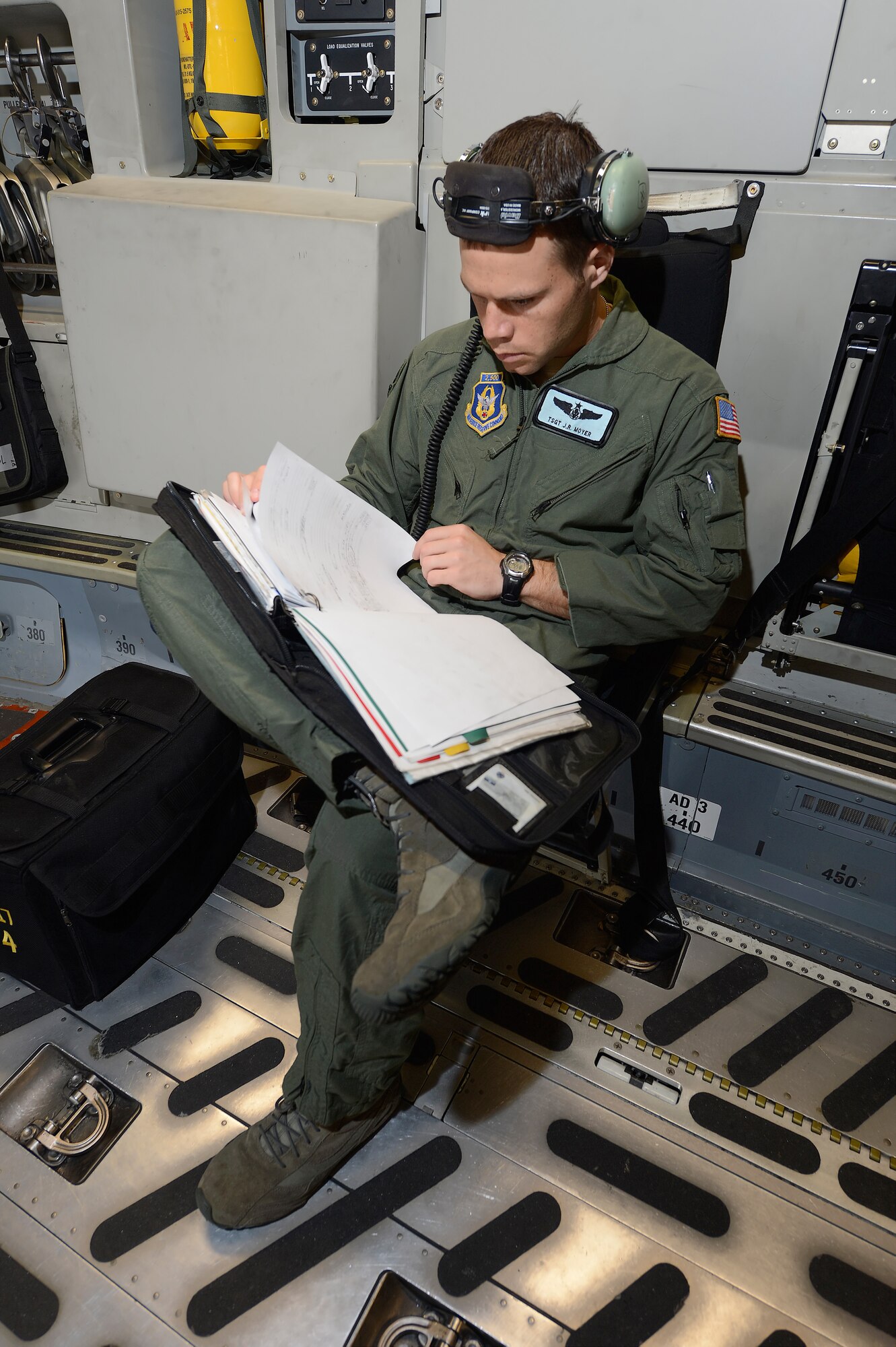 Technical Sgt. J. R. Moyer, a C-17A loadmaster with the 326th Airlift Squadron, 512th Airlift Wing, Air Force Reserve Command, reviews the aircrafts' maintenance forms before accepting it from maintenance for a training mission on June 18, 2013, at Dover Air Force Base, Del. Dover's fleet of C-5M and C-17A's are shared by active duty (436th) and reserve (512th) Wings.  (U.S. Air Force photo/Greg L. Davis)