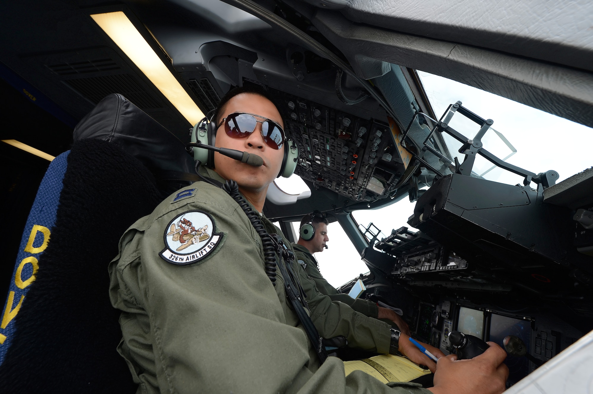 Capt. Oneff Reyes (foreground) and Maj. Rich Polehemus, of the 326th Airlift Squadron, 512th Airlift Wing, Air Force Reserve Command, shown on the flightdeck of a C-17A Globemaster III during a training mission from Dover Air Force Base, Del., on June 18, 2013. Dover's fleet of C-5M and C-17A's are shared by active duty (436th) and reserve (512th) Wings. (U.S. Air Force photo/Greg L. Davis)