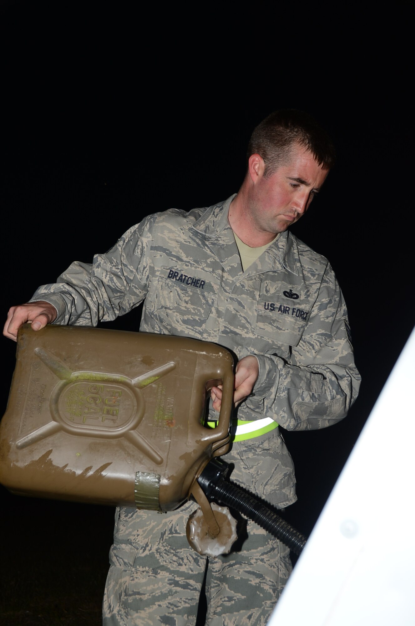 ROYAL AIR FORCE LAKENHEATH, England – Staff Sgt. Stephen Bratcher, 48th Security Forces Squadron vehicle section NCO in charge, fuels a light generator at the entry control point of a Phase II Exercise June 18, 2013. Bratcher was nominated for a Liberty Spotlight because he displays the core value of “Service Before Self.” (U.S. Air Force photo by Airman 1st Class Trevor T. McBride)