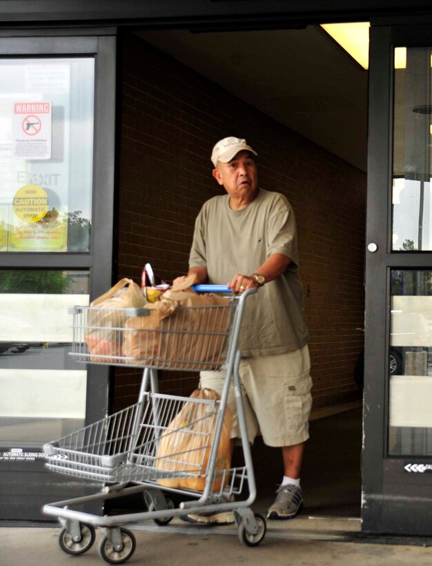 A commissary patron carts groceries to his car June 17, 2013, at Joint Base Andrews, Md.  The Andrews Commissary is slated to close on Mondays from July 8 through Sept. 30 due to a sequester-driven furlough on DoD civilian employees. (U.S. Air Force photo/Staff Sgt. Torey Griffith)