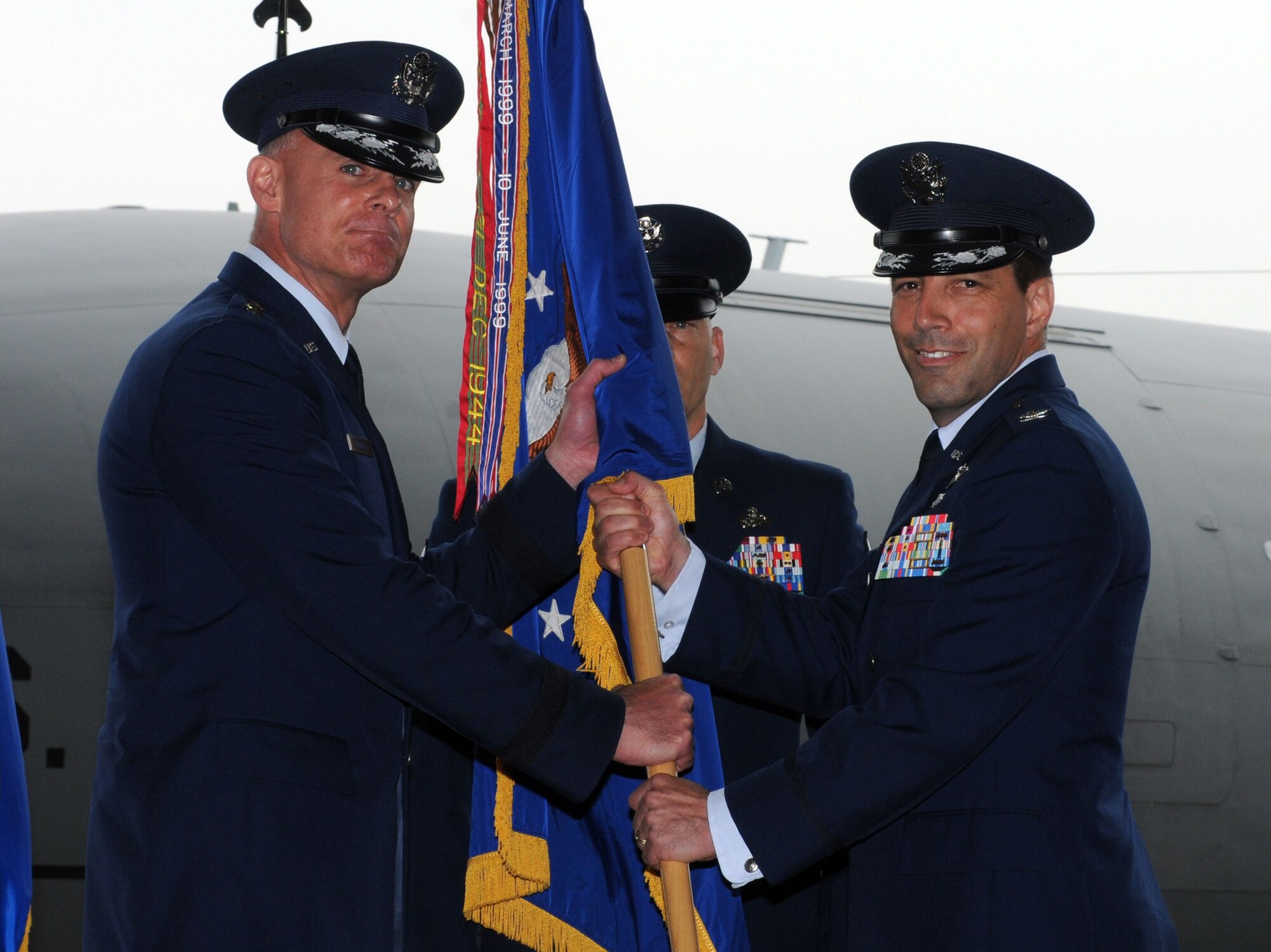 From right, Col. Christopher Kulas, outgoing 100th Air Refueling Wing commander, relinquishes command of the 100th ARW to Lt. Gen. Craig Franklin, 3rd Air Force commander, Ramstein Air Base, Germany, during the 100th ARW change of command ceremony June 19, 2013, on RAF Mildenhall, England. Kulas and his family are moving to Washington D.C. where he will serve as the Director of Air Force Colonel Management at the Pentagon. (U.S. Air Force photo by Staff Sgt. Tabitha M. Lee/Released)
