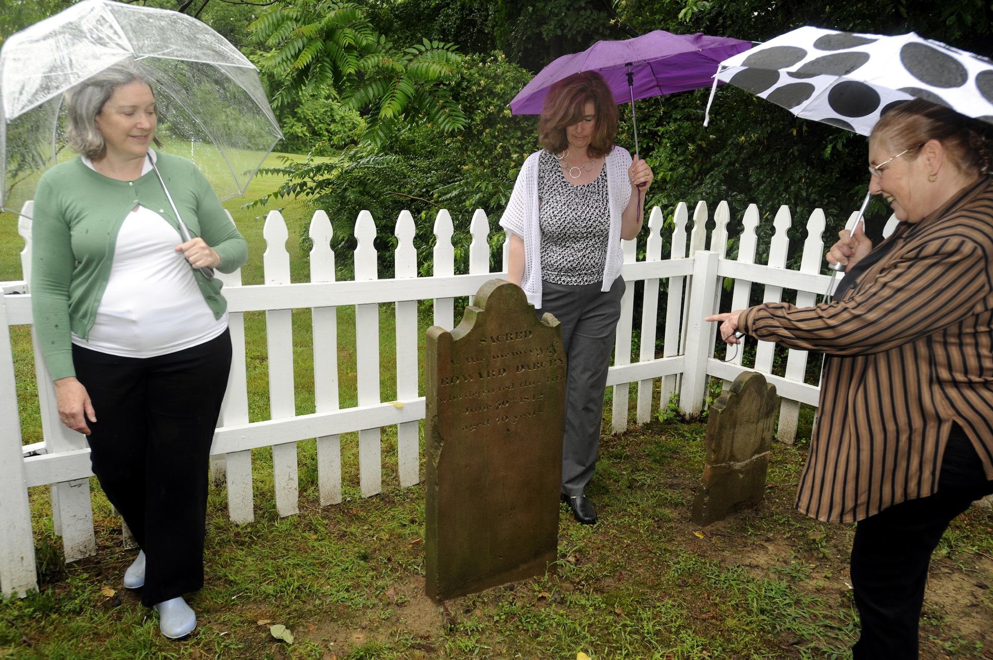 Darcey family descendants Sandra Curtin, Shelly Muffley and Lee Green view the gravesites of Edward and Hannah Darcey on June 7, 2013. The Darcey family gravesite at Belle Chance, Joint Base Andrews, Md., date back to the nineteenth century and is one of several private cemeteries in Prince George’s County.  (U.S. Air Force photo/Aletha Frost)