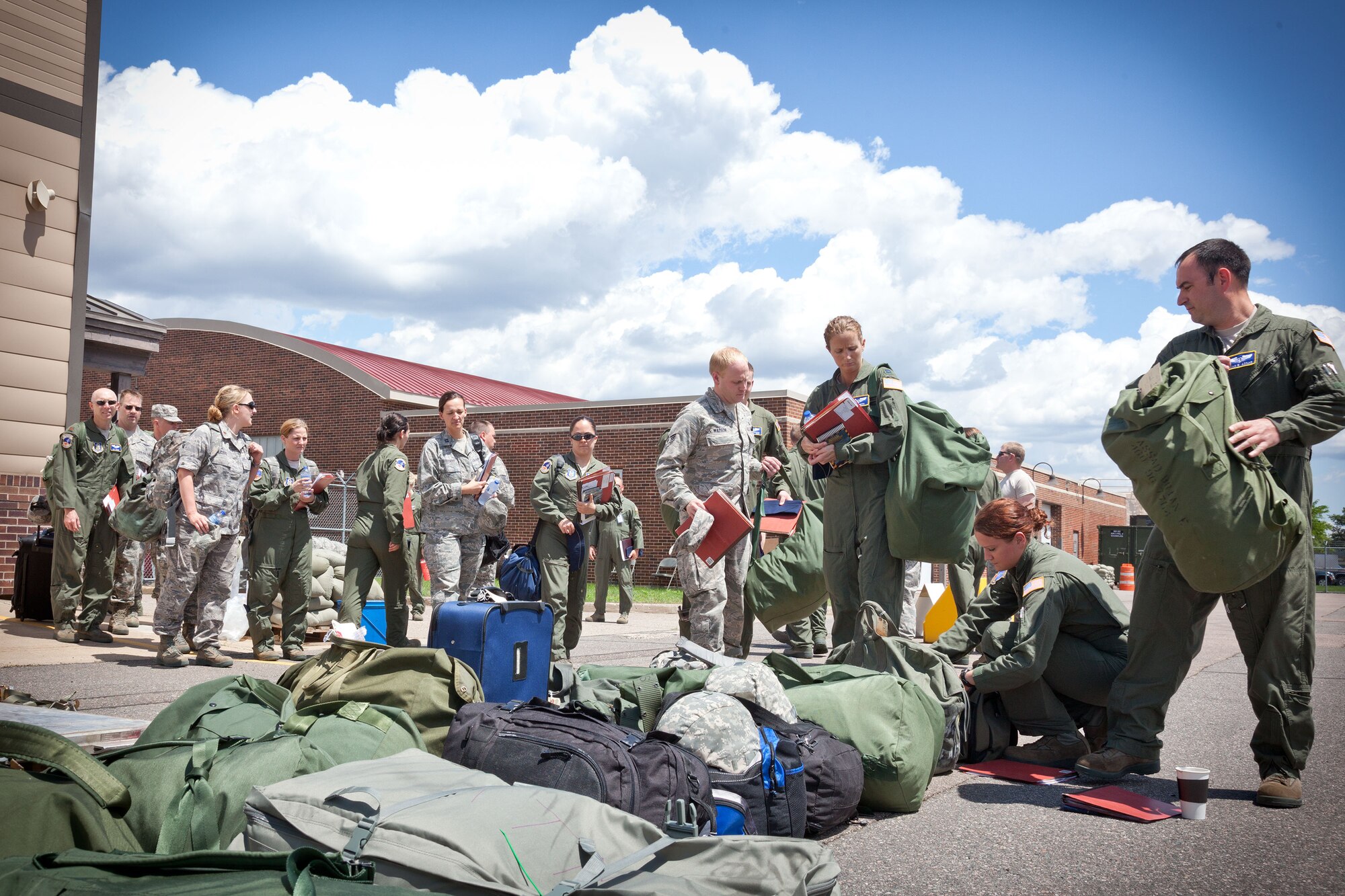 Airmen drop their personal and mobility bags as they in-process for a mock deployment.  Members of the 934th Airlift Wing participated in an Operational Readiness Exercise during the week of June 17-21 at the Minneapolis-St. Paul Air Reserve Station, Minn.  (U.S. Air Force photo/Shannon McKay)