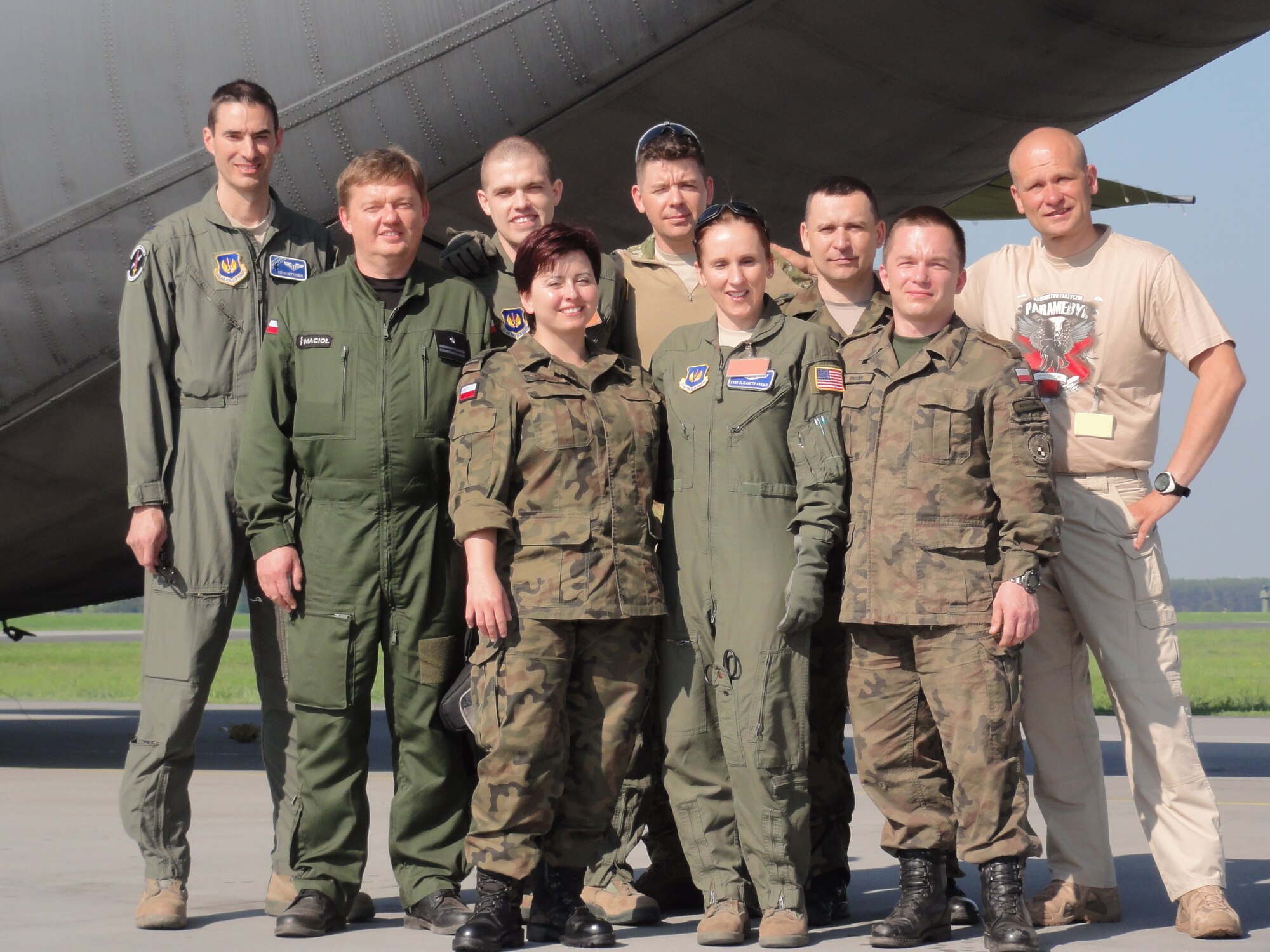 Ramstein Airmen from the 86th Aeromedical Evacuation Squadron and 435th Contingency Response Group pose for a photo with the Polish AE team May 9, 2013, Powidz Air Base, Poland. The Polish air force has consistently engaged in AE training and familiarization with Ramstein Airmen throughout 2012 and 2013. (courtesy photo illustration) 