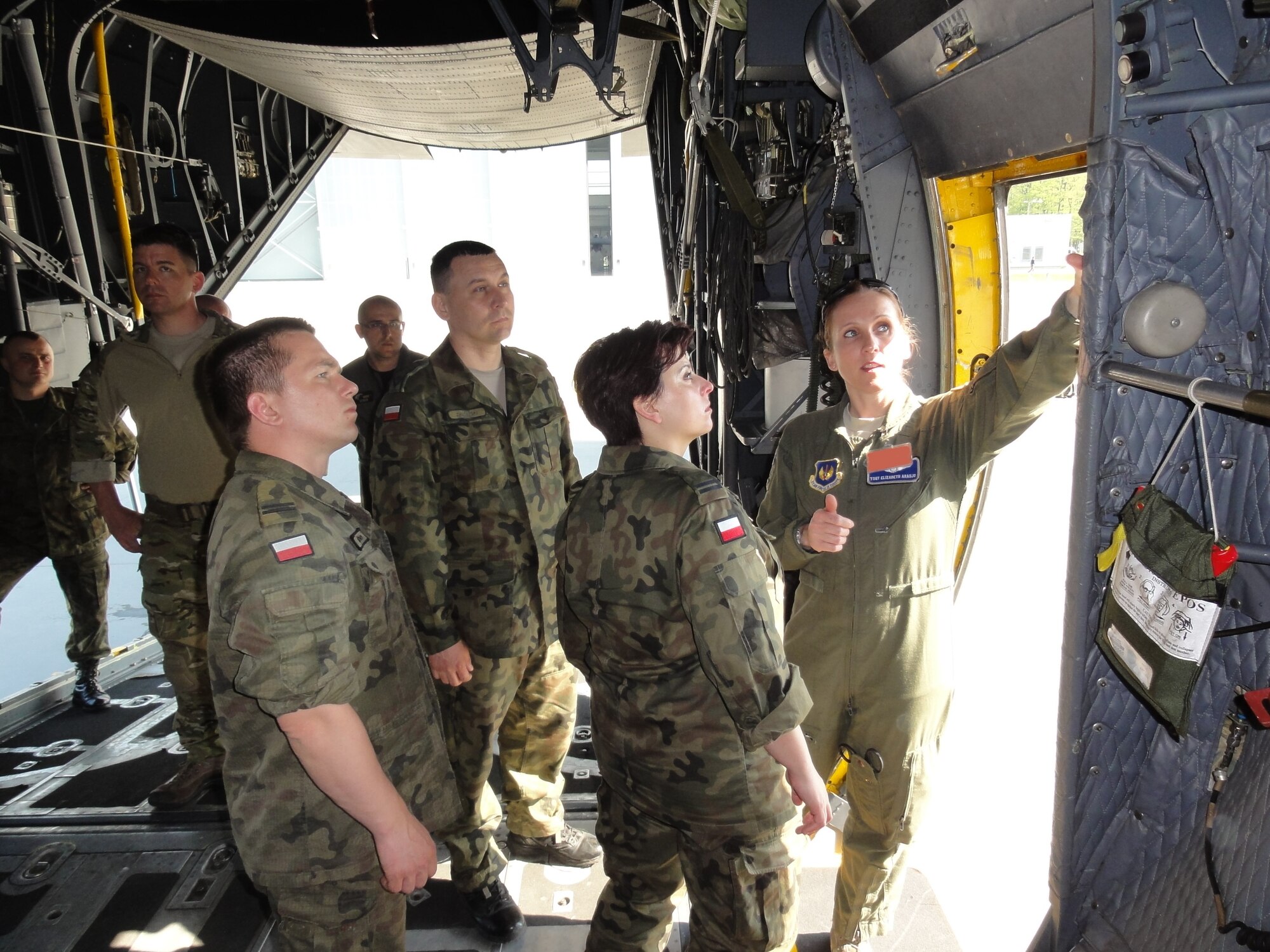 Tech. Sgt. Elizabeth Araujo, 86th Aeromedical Evacuation Squadron, discusses tactics with the Polish AE team in May 9, 2013, Powidz Air Base, Poland. The Polish air force has consistently engaged in AE training and familiarization with Ramstein Airmen throughout 2012 and 2013. (U.S. Air Force photo illustration / Lt. Col. Kevin Hettinger) 